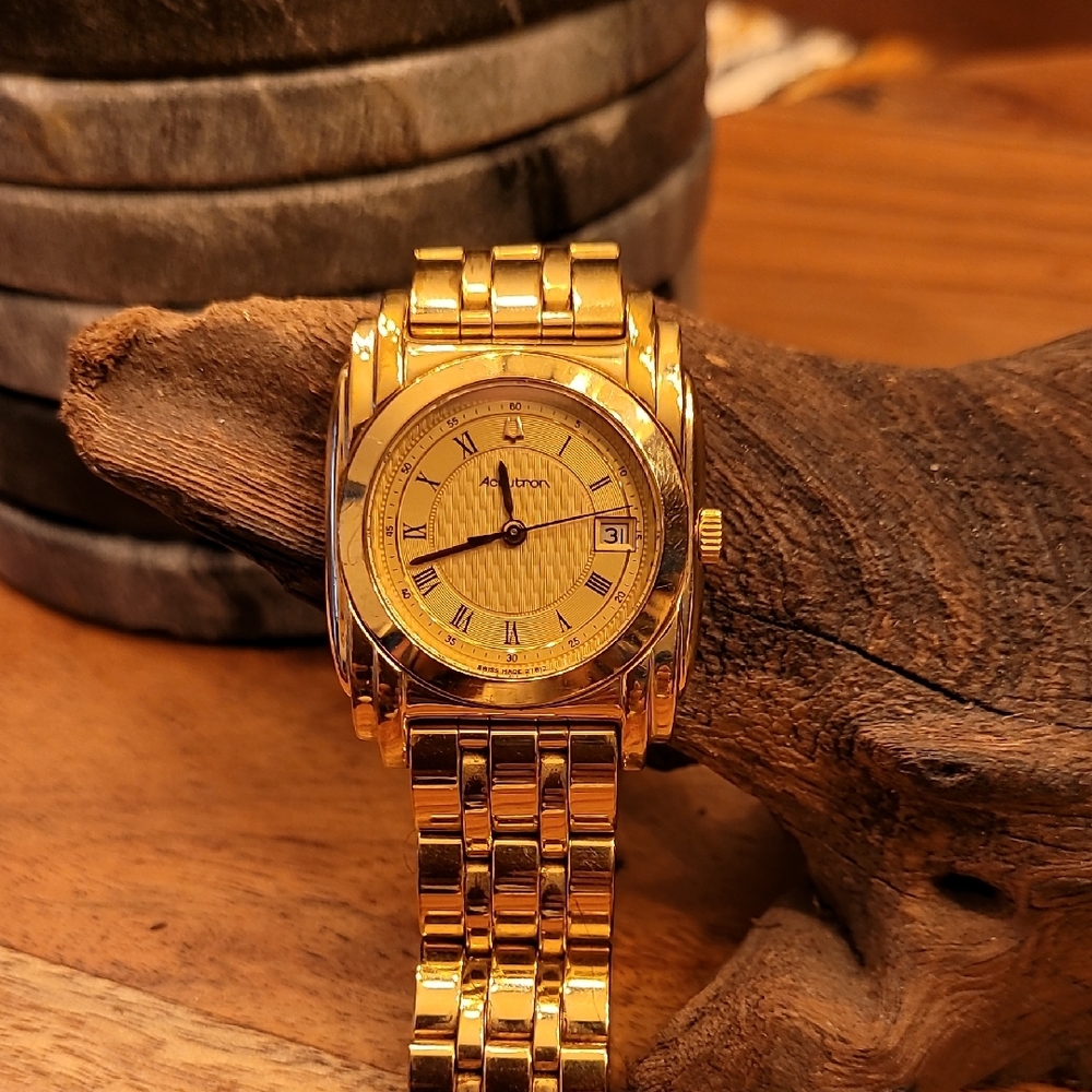 Accutron men's gold watch with linked band.